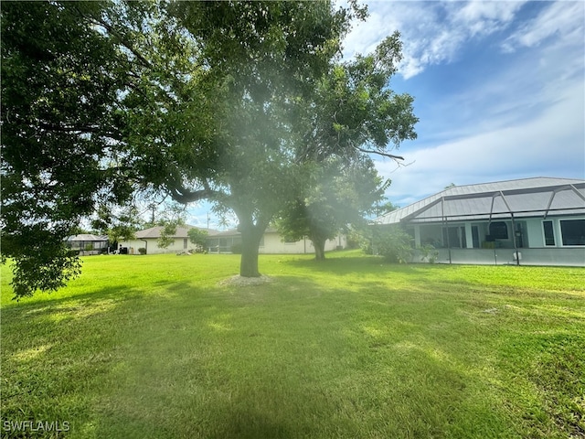 view of yard featuring glass enclosure