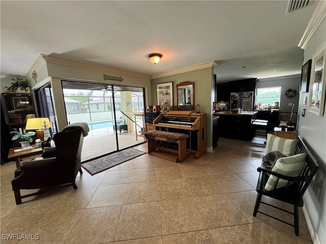 living room with ornamental molding and light tile patterned floors