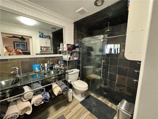 bathroom with decorative backsplash, sink, tile walls, and walk in shower