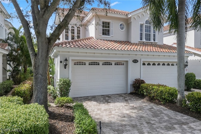 mediterranean / spanish house featuring a garage