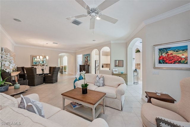 tiled living room with ceiling fan with notable chandelier and ornamental molding