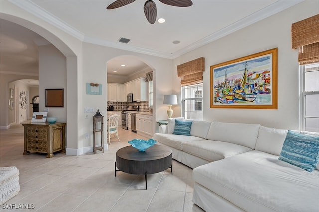 tiled living room with crown molding and ceiling fan