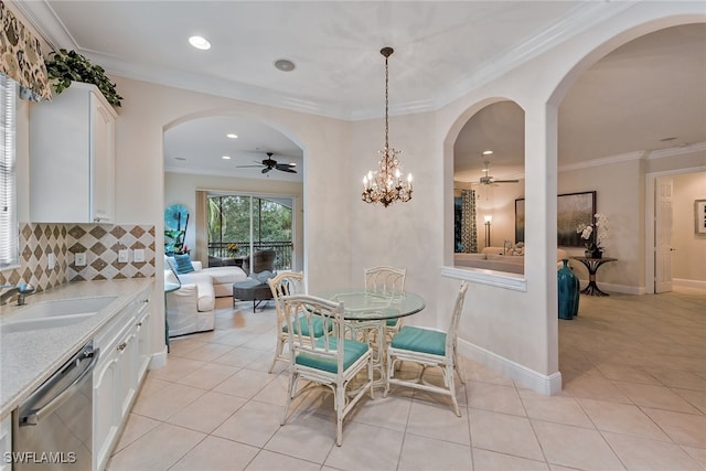 interior space featuring ceiling fan with notable chandelier, white cabinets, and dishwasher