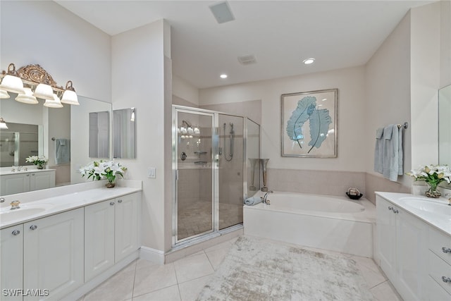 bathroom with tile patterned floors, vanity, and separate shower and tub