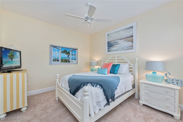 bedroom with ceiling fan and light carpet