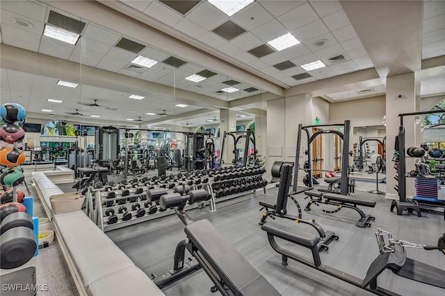 workout area with a drop ceiling and plenty of natural light