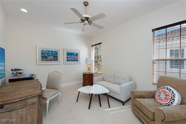 carpeted office space featuring ceiling fan