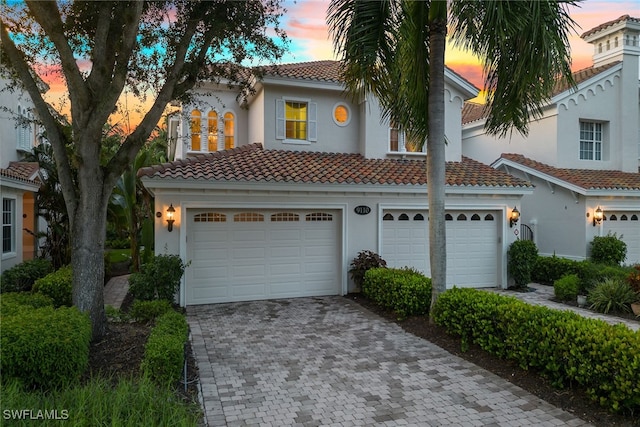 mediterranean / spanish home with a garage