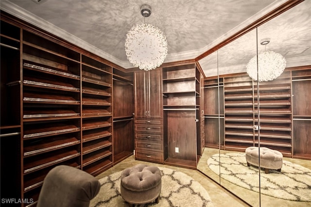 spacious closet featuring a notable chandelier