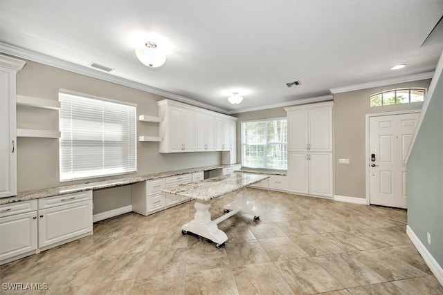 kitchen with light stone counters and white cabinets