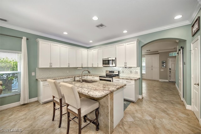 kitchen with sink, appliances with stainless steel finishes, and white cabinetry