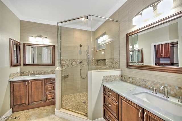 bathroom with vanity, ornamental molding, and walk in shower