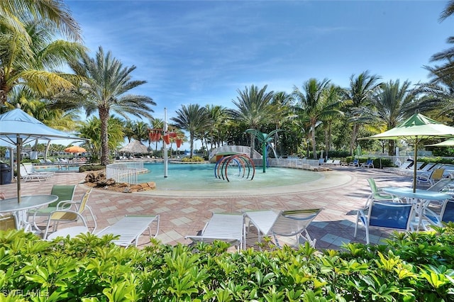 view of pool with a patio and pool water feature