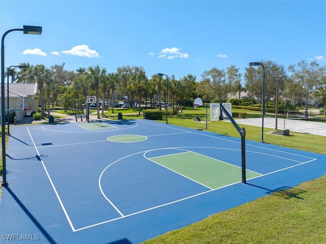 view of sport court with a yard