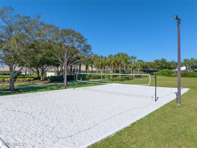 view of community with a lawn and volleyball court