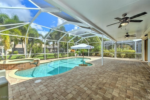 view of pool with a lanai, an in ground hot tub, ceiling fan, and a patio