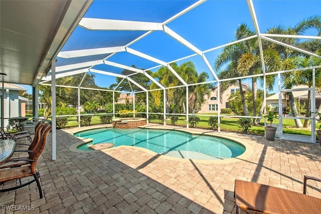 view of pool with a lanai, a patio, and an in ground hot tub