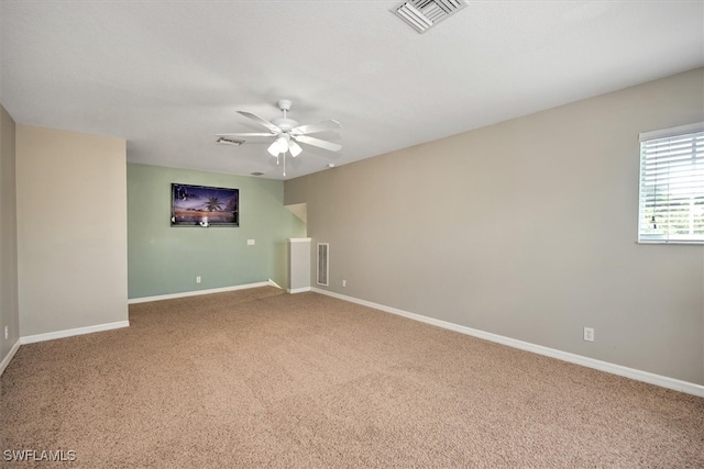 empty room with ceiling fan and carpet