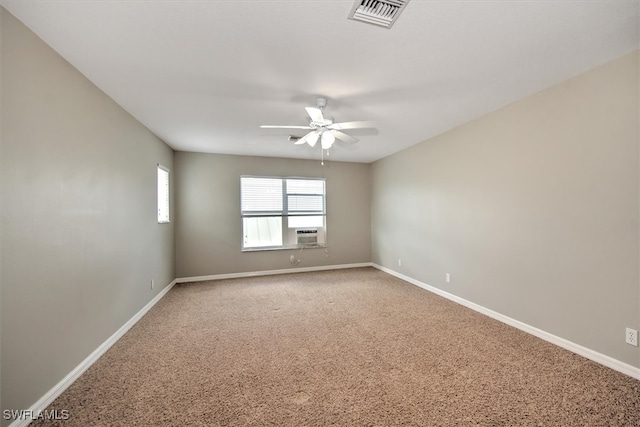 carpeted spare room featuring cooling unit and ceiling fan