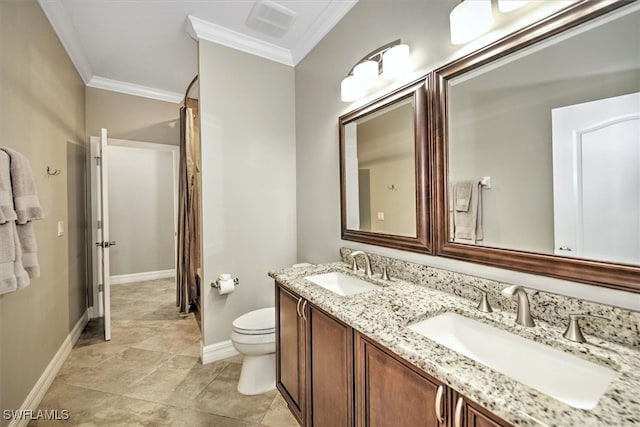 bathroom with crown molding, vanity, and toilet