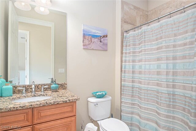 bathroom with a shower with shower curtain, toilet, and vanity