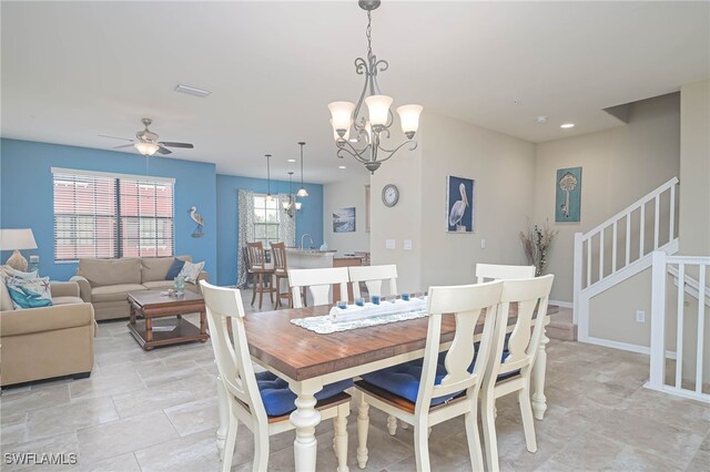 dining room with ceiling fan with notable chandelier and light tile patterned floors