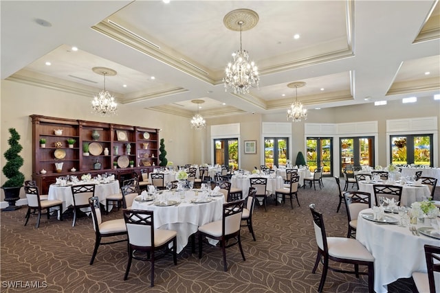 dining space with dark carpet, french doors, an inviting chandelier, and ornamental molding