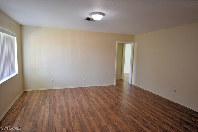 unfurnished room featuring dark hardwood / wood-style flooring