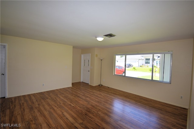 spare room with dark hardwood / wood-style floors