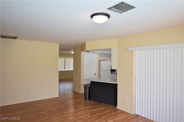 unfurnished room featuring dark hardwood / wood-style flooring