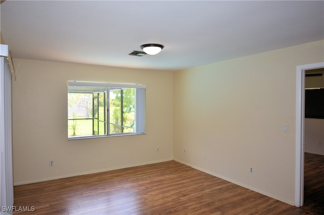 empty room featuring dark hardwood / wood-style flooring