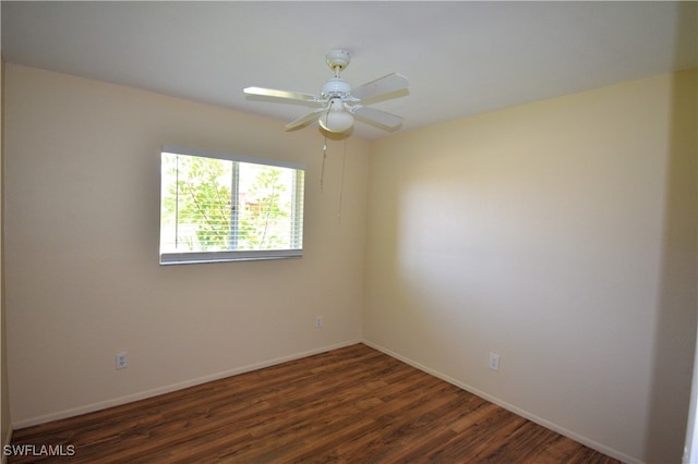 empty room featuring ceiling fan and dark hardwood / wood-style flooring