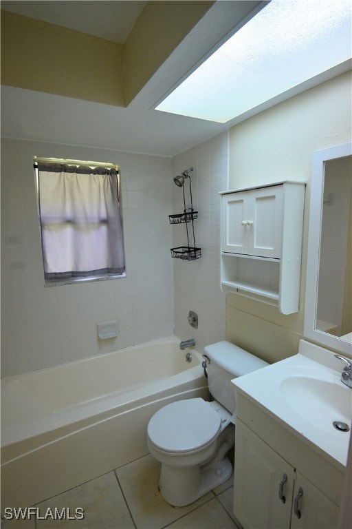 full bathroom with tiled shower / bath, vanity, toilet, and tile patterned floors