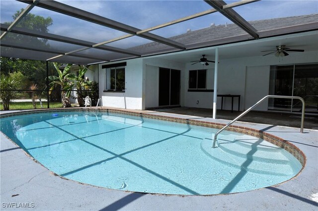 view of pool with ceiling fan, a lanai, and a patio