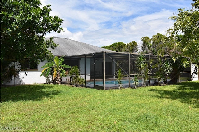 view of yard with glass enclosure