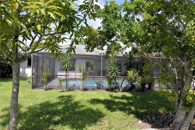 view of yard featuring glass enclosure