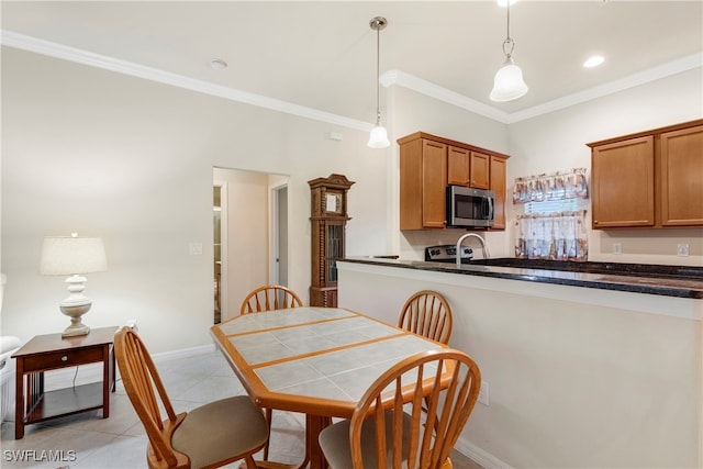 tiled dining area with crown molding and sink