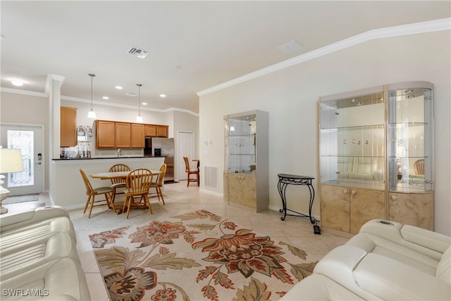 living room with light tile patterned floors and crown molding