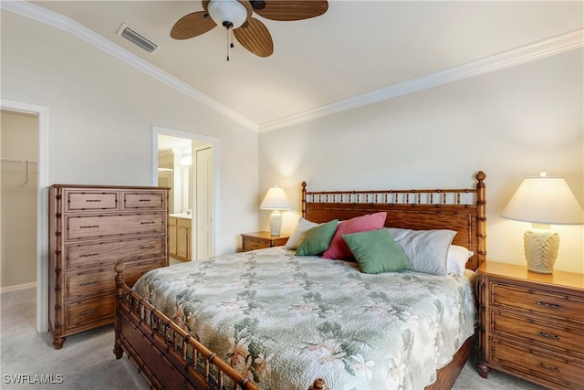 bedroom featuring a walk in closet, light carpet, a closet, and ornamental molding