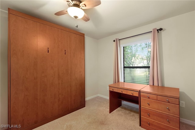 office area with ceiling fan and light carpet