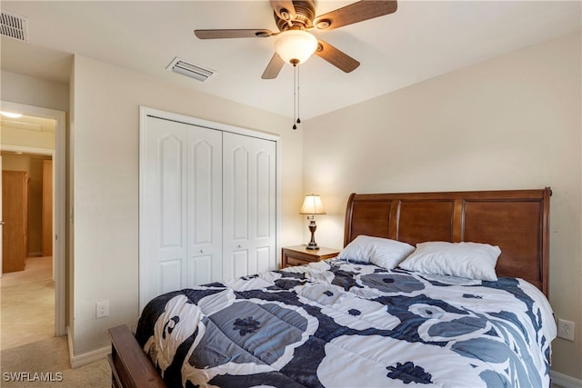 carpeted bedroom with ceiling fan and a closet