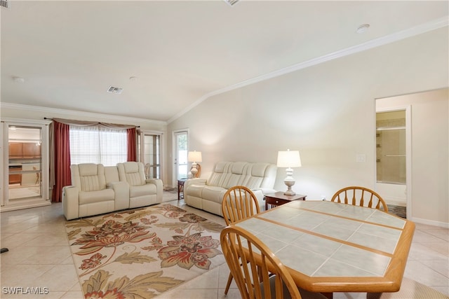 dining space with light tile patterned floors, vaulted ceiling, and ornamental molding