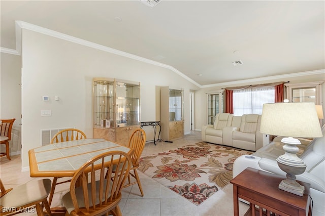 living room featuring lofted ceiling, ornamental molding, and light tile patterned flooring