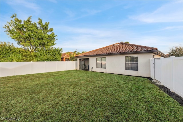 rear view of house featuring a lawn