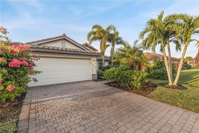 view of front of home with a garage and a front lawn