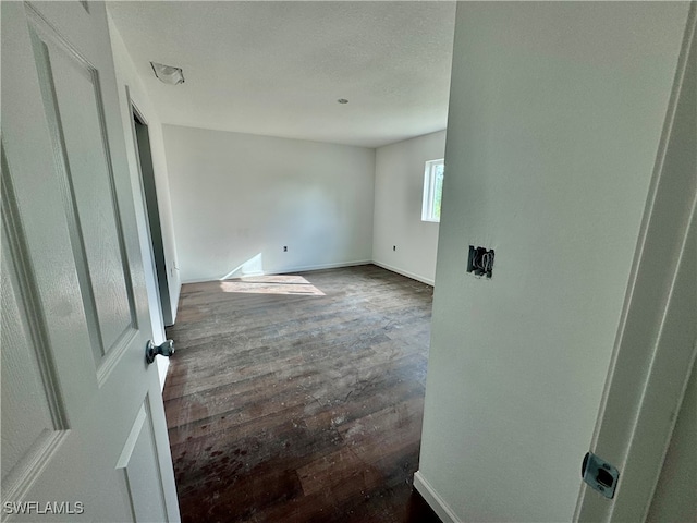 spare room with dark hardwood / wood-style floors