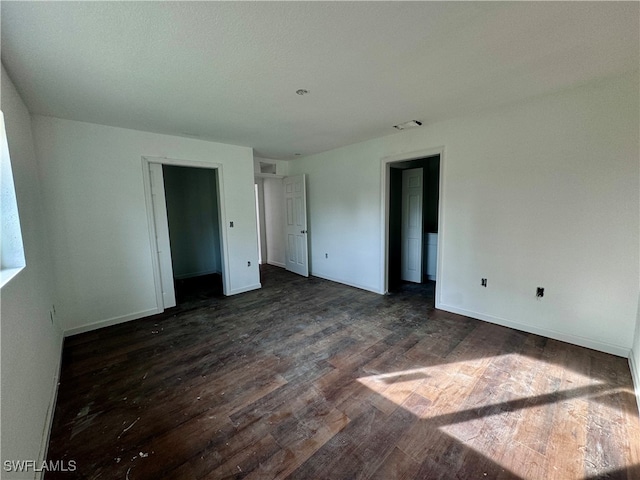 empty room with dark hardwood / wood-style flooring