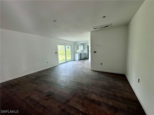 empty room with dark hardwood / wood-style flooring