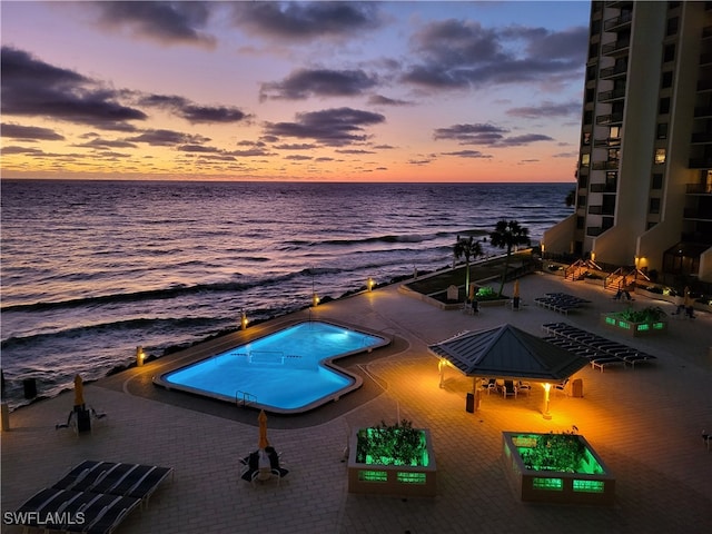 pool at dusk with a water view