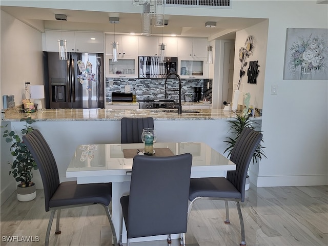 dining area featuring light hardwood / wood-style floors and sink